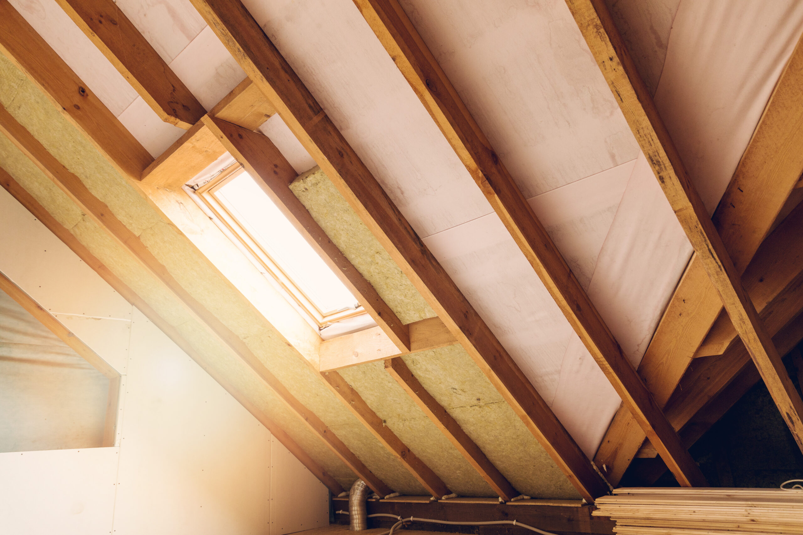 Wooden beams with skylight in attic