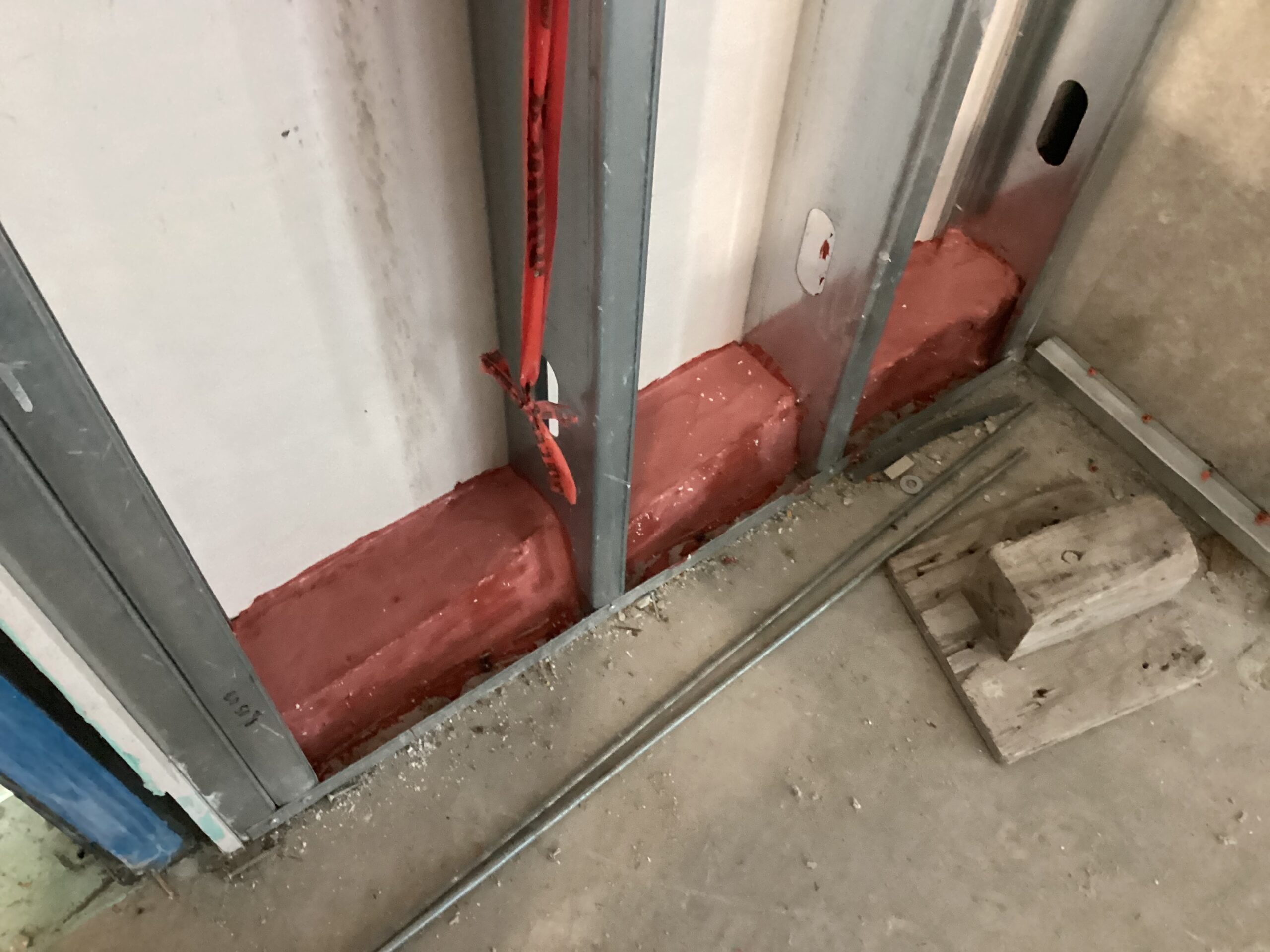 Red firestop material in construction area